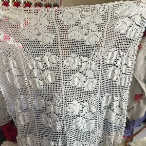Hand made crochet table cloth of roses.